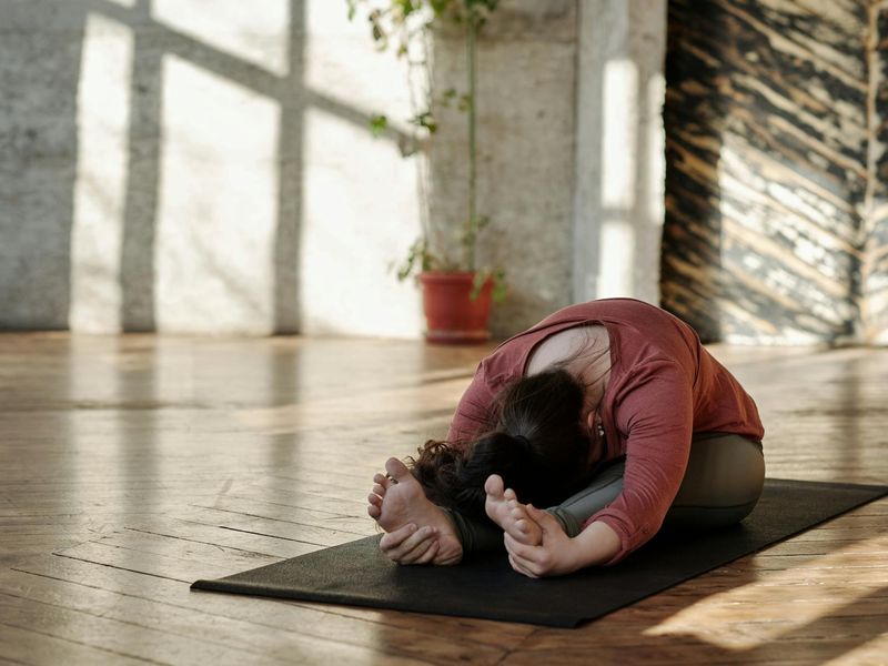 Person practicing mindfulness exercises in a sunlit room.